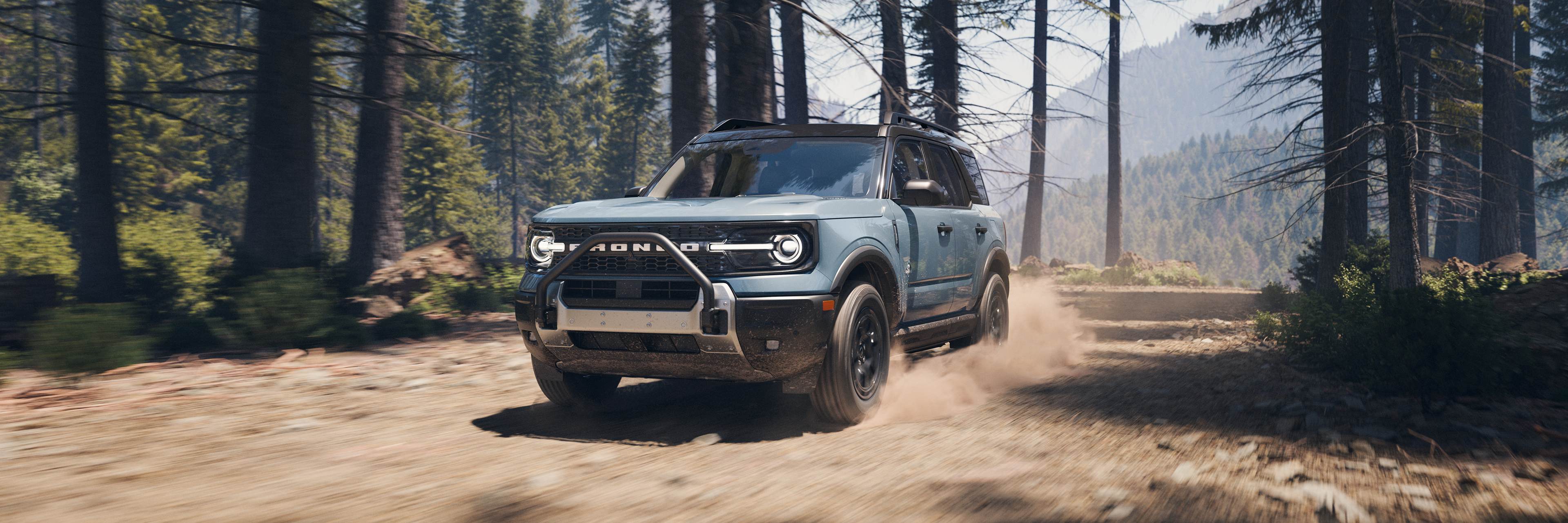 Ford Bronco Sport Badlands driving quickly on a forest dirt road