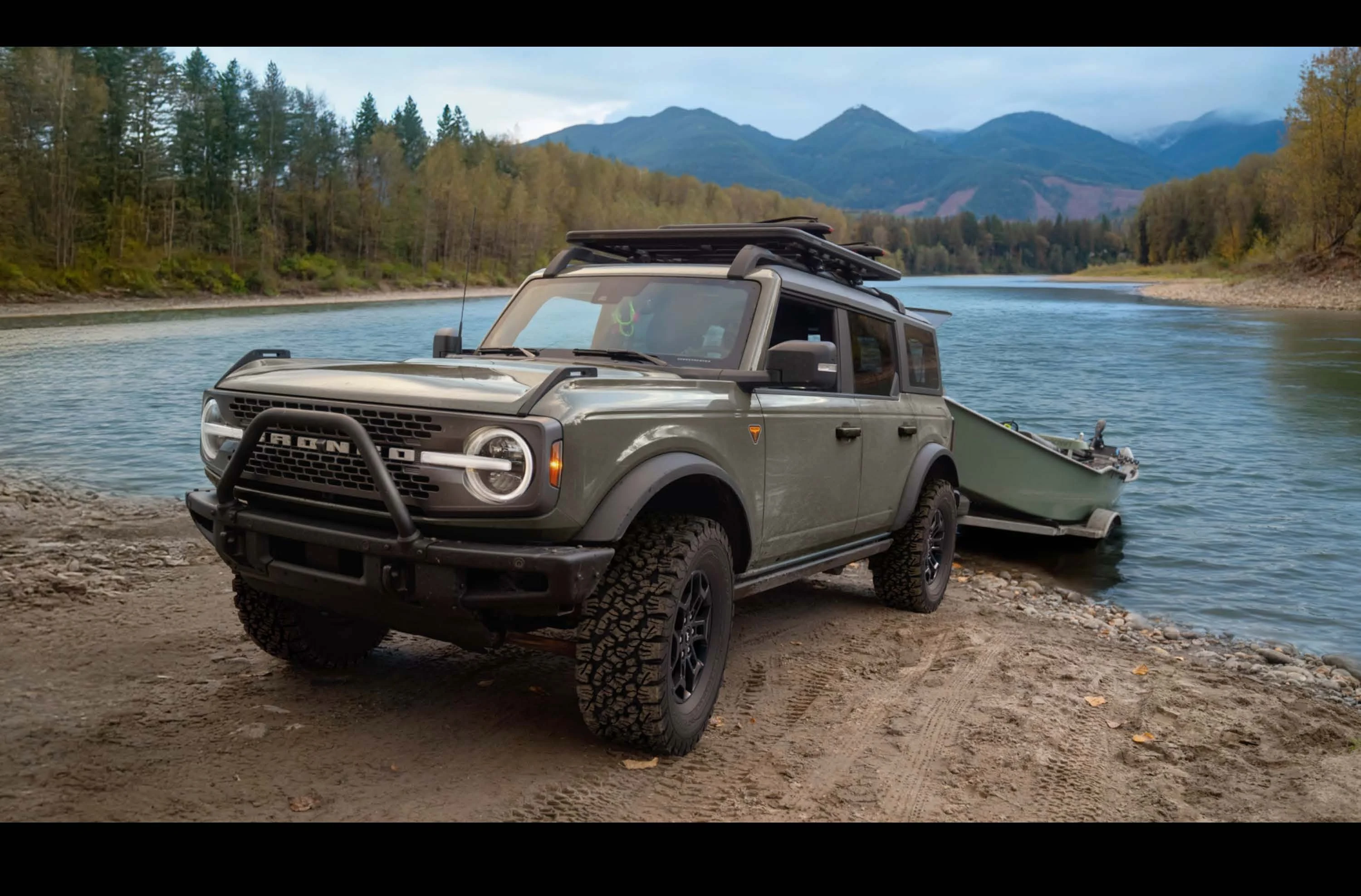 2026 Ford Bronco at a mountain lake with a boat trailer